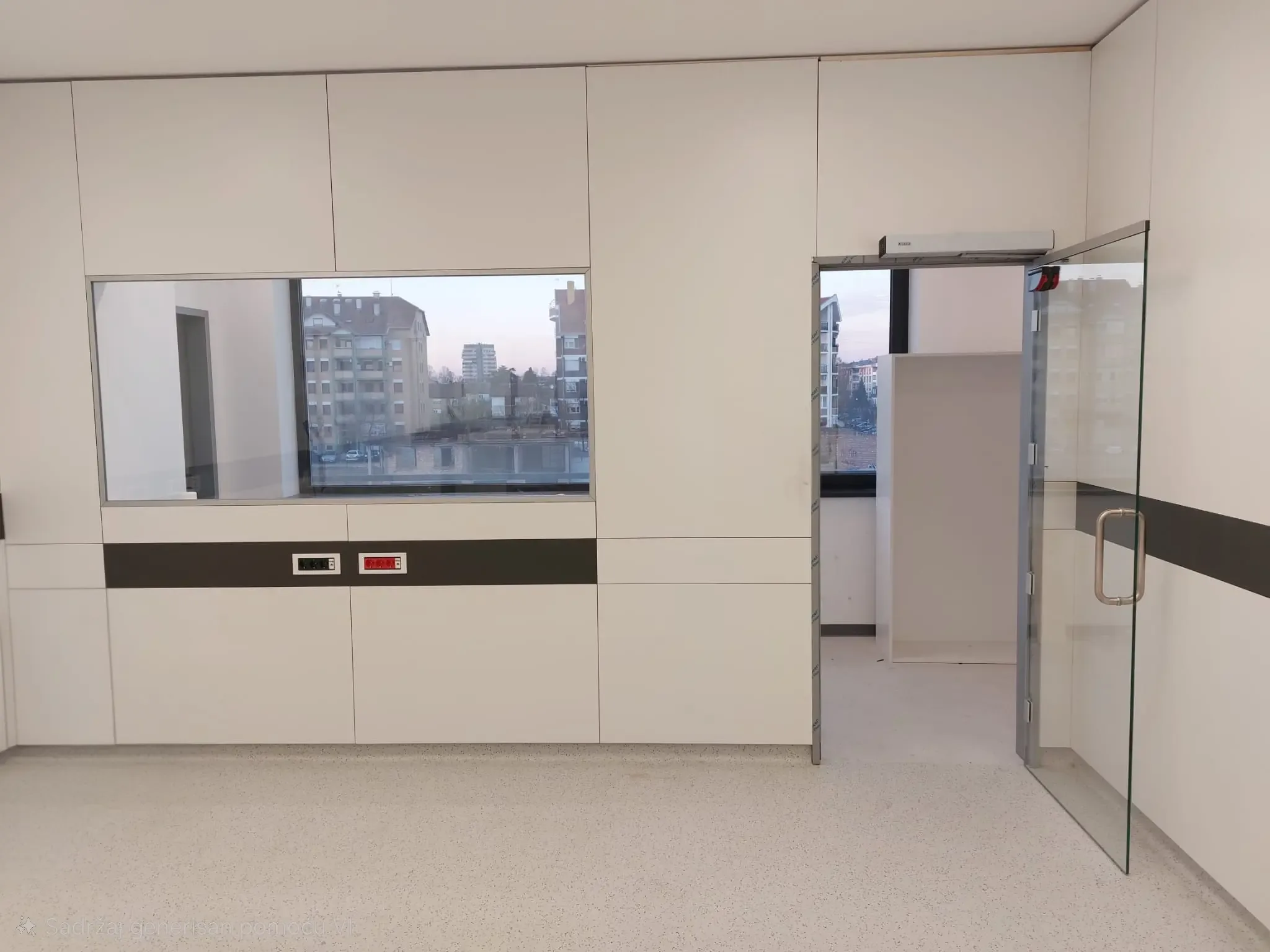 A glazed swing door with a vertical pull handle beside white wall cladding with a window and counter
