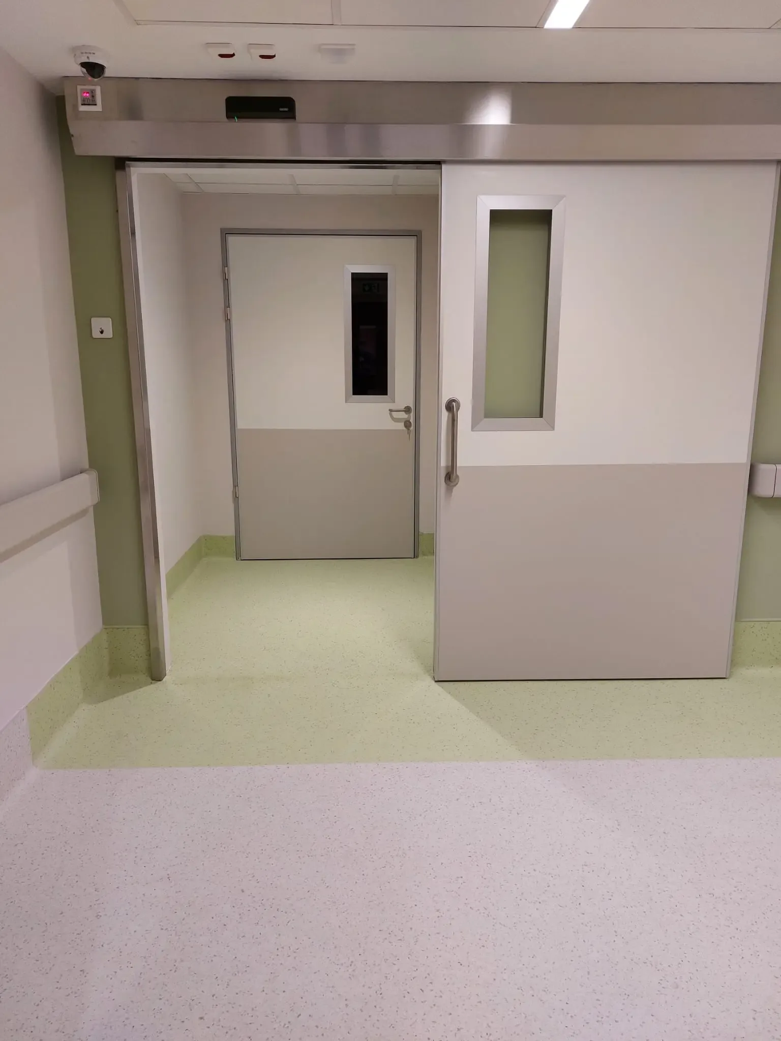 An open hermetic sliding door with the drive in a stainless steel housing above the opening