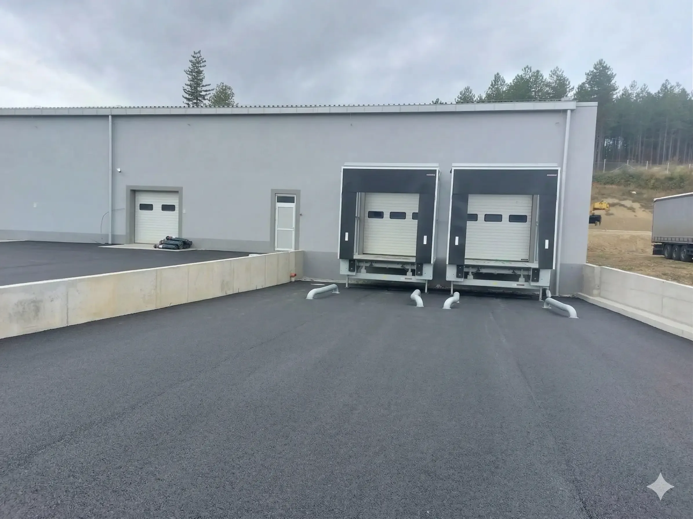 Two loading bays with dock levellers on the façade of a logistics building