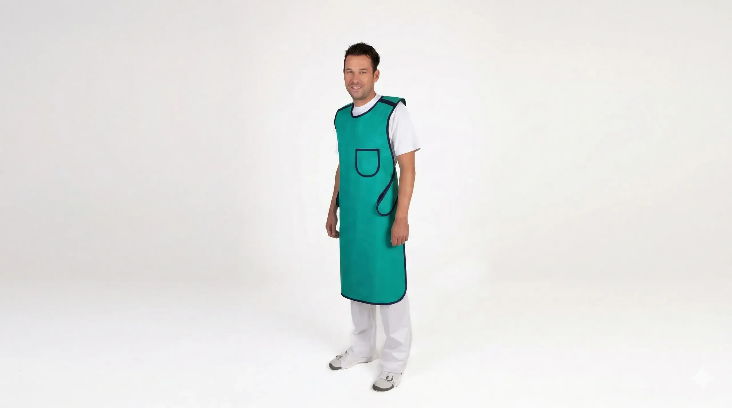 A green protective lead apron with a pocket, worn by a person